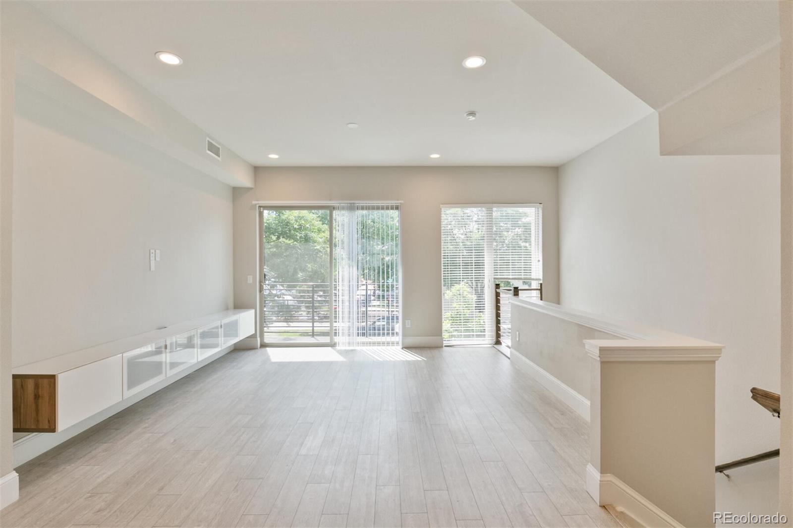 1014 Acoma Street Denver, CO 80204 - Photo 9 of 35 a view of an empty room with wooden floor and a window