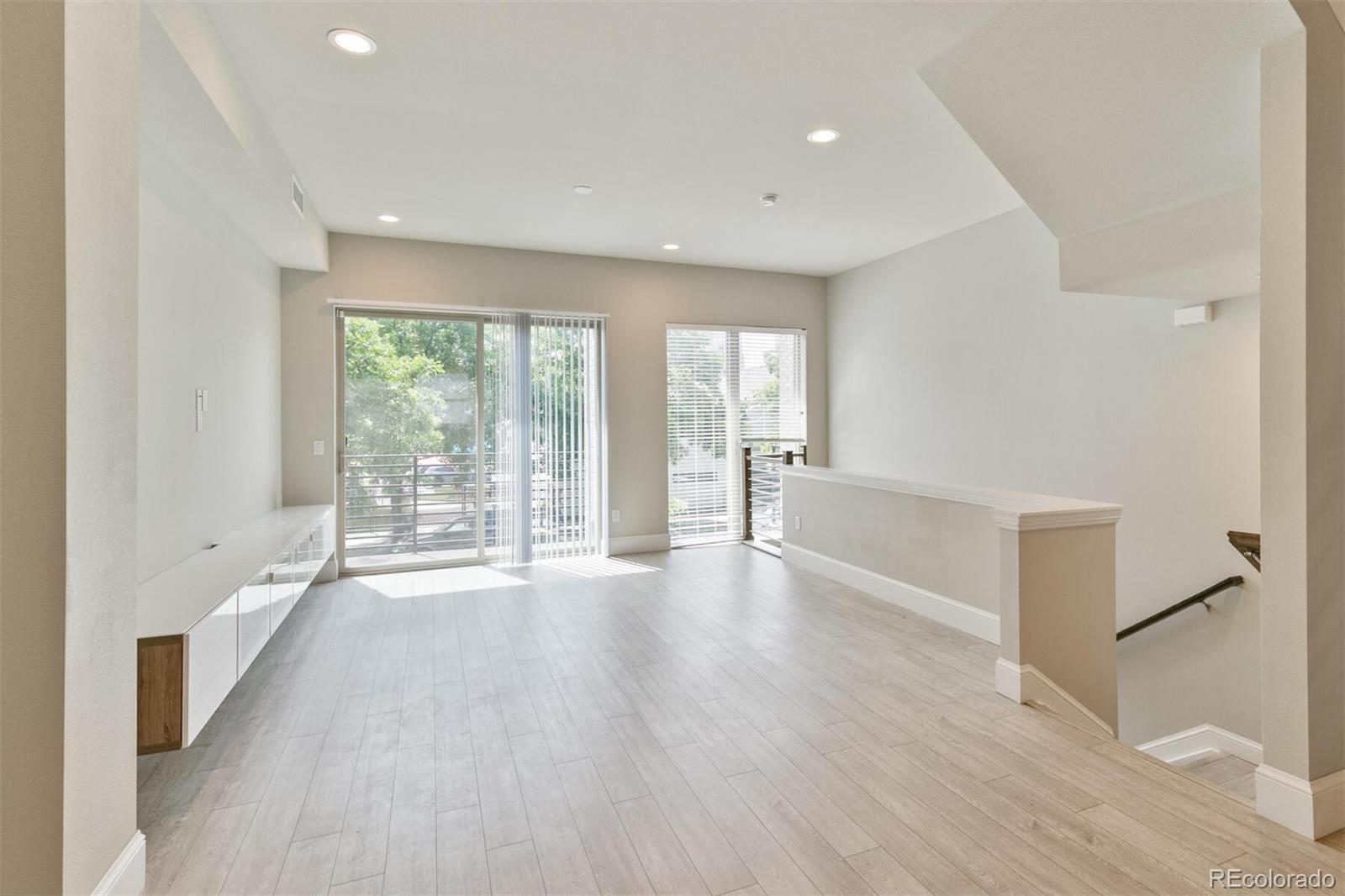 1014 Acoma Street Denver, CO 80204 - Photo 10 of 35 wooden floor in an empty room with a window