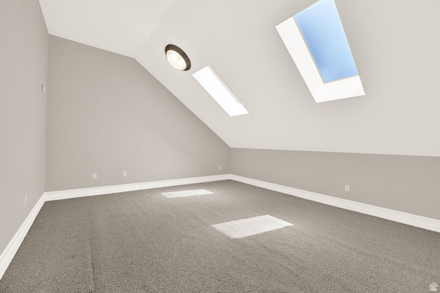 4792 Glasmann Way South Ogden, UT 84403 - Photo 54 of 70 Multipurpose room on upper-level room featuring two skylights, a sloped ceiling, and a flush-mount ceiling light fixture with access via ladder