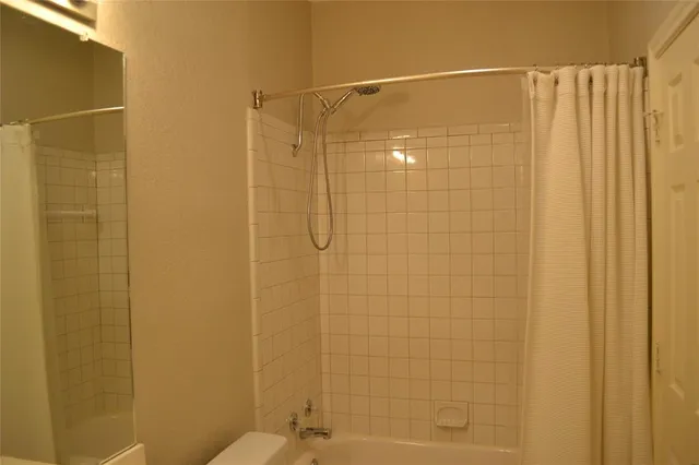 a view of a small space with wooden floor and a window