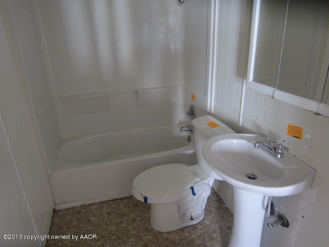 4130 South Tyler Street Amarillo, TX 79110 - Photo 10 of 15 a bathroom with a sink a toilet and shower