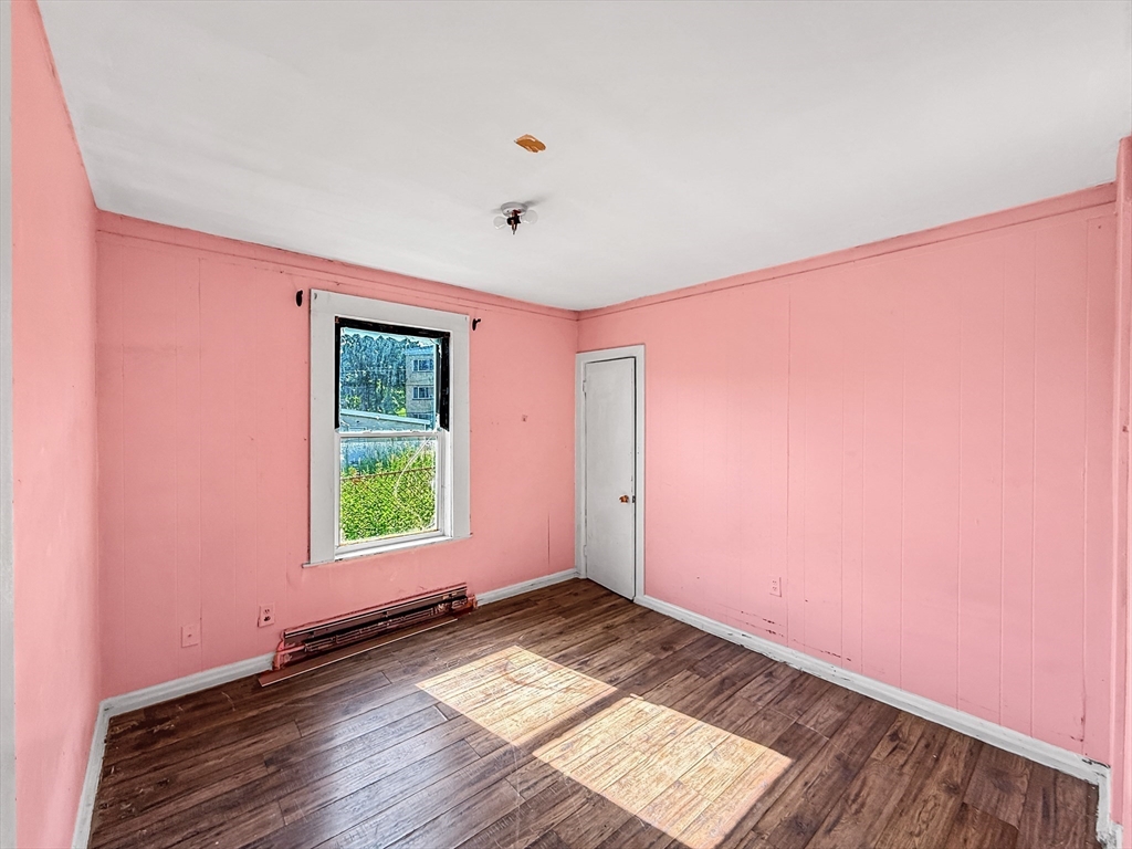 19 High Street Lynn, MA 01902 - Photo 11 of 42 an empty room with wooden floor and windows