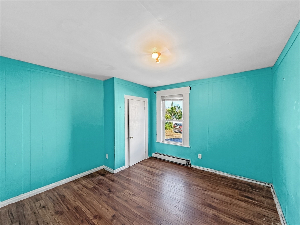19 High Street Lynn, MA 01902 - Photo 12 of 42 an empty room with wooden floor and windows