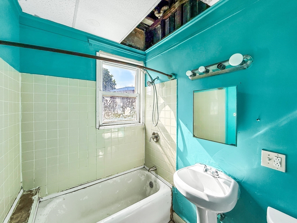 19 High Street Lynn, MA 01902 - Photo 14 of 42 a bathroom with a sink and a mirror