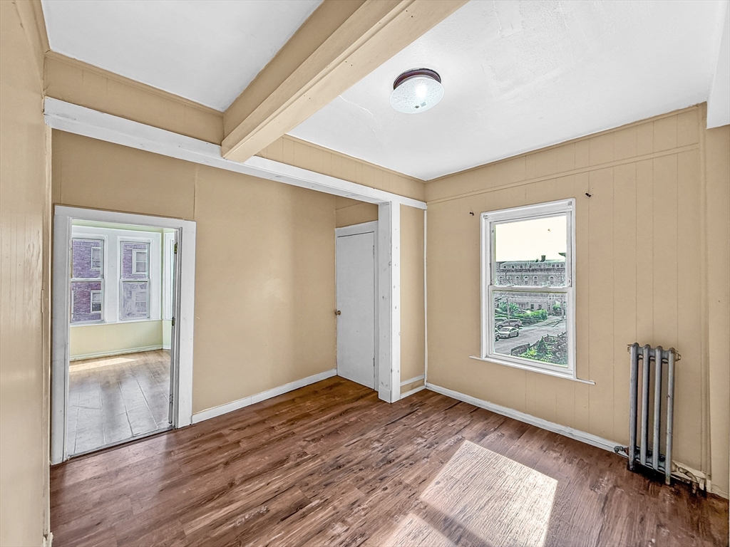 19 High Street Lynn, MA 01902 - Photo 18 of 42 an empty room with wooden floor and windows