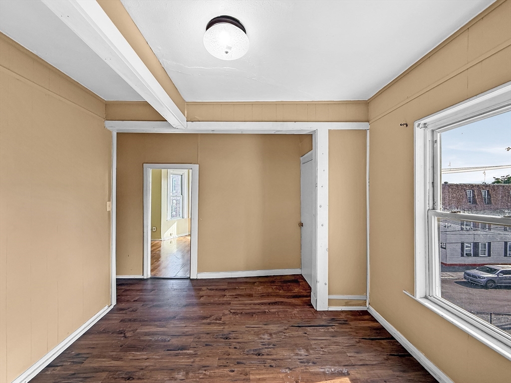 19 High Street Lynn, MA 01902 - Photo 19 of 42 a view of an empty room with wooden floor and a window
