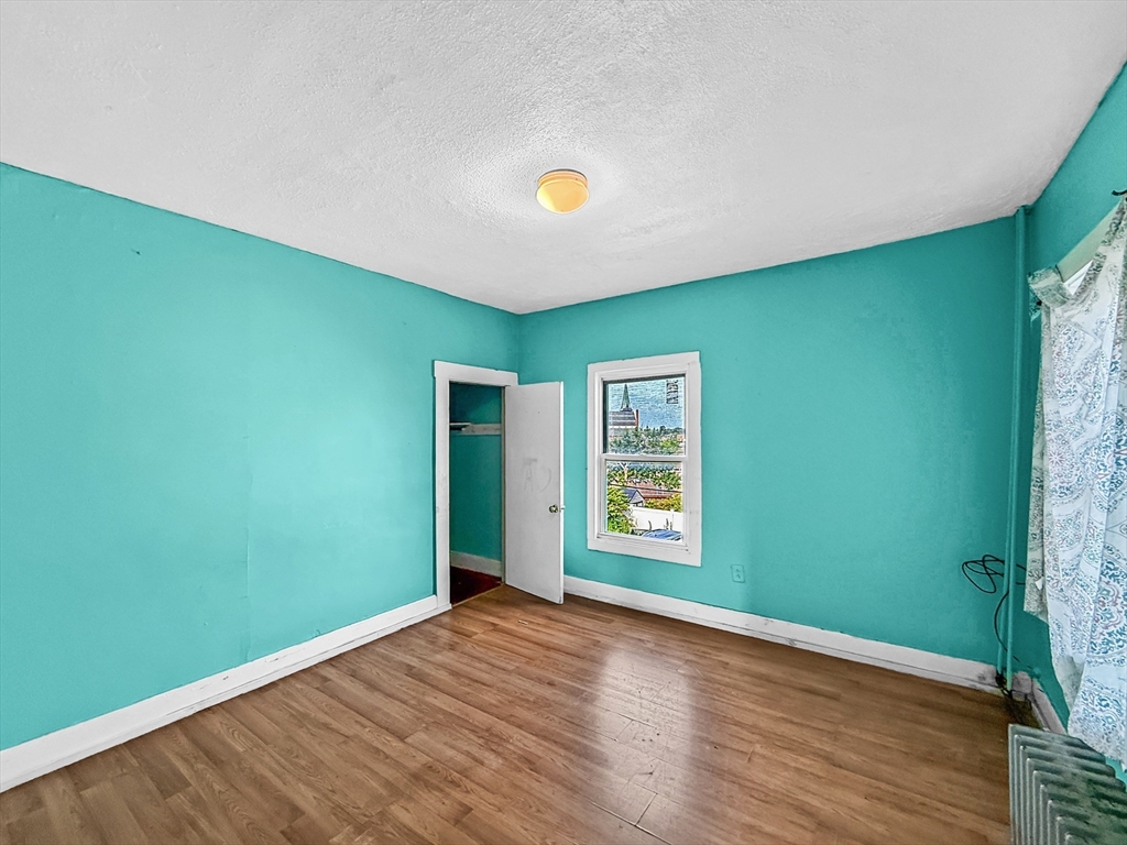 19 High Street Lynn, MA 01902 - Photo 24 of 42 a view of empty room with window and wooden floor