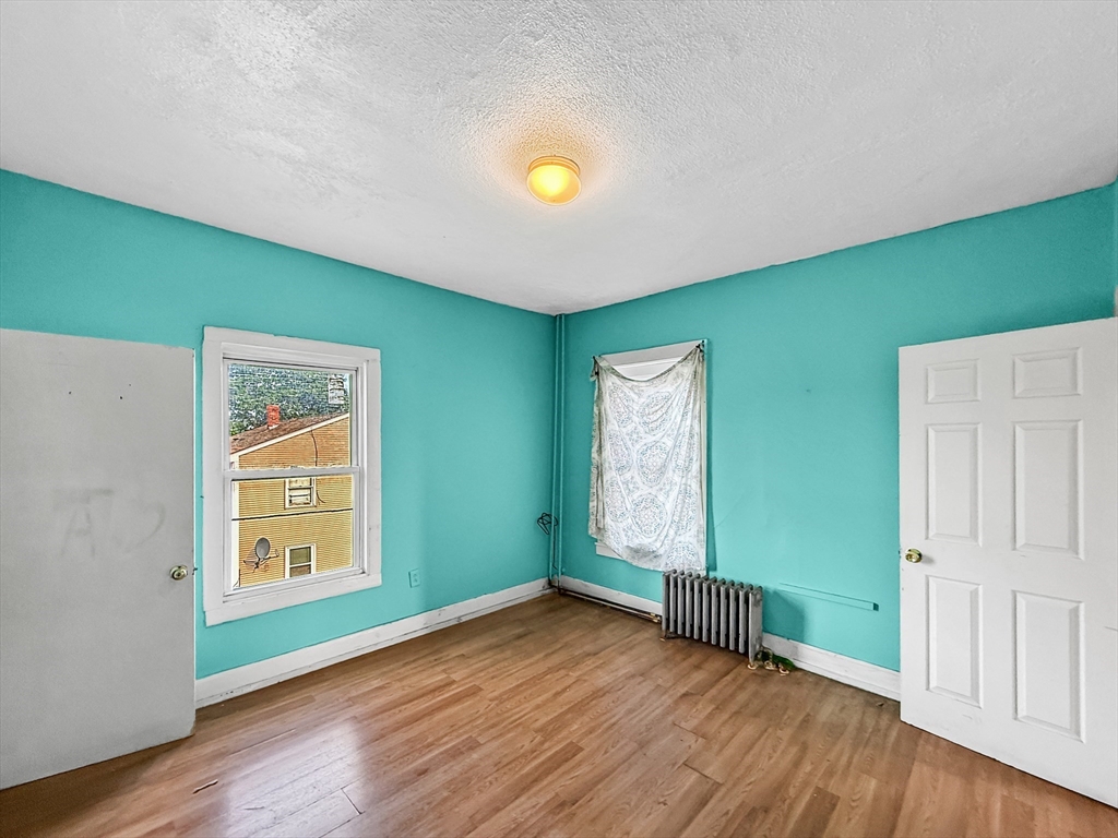 19 High Street Lynn, MA 01902 - Photo 25 of 42 a view of an empty room with window and wooden floor
