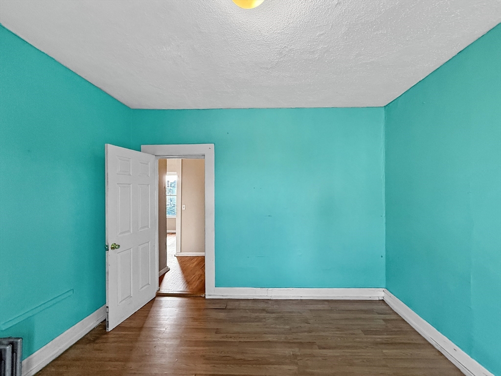 19 High Street Lynn, MA 01902 - Photo 26 of 42 a view of an empty room with wooden floor and a window