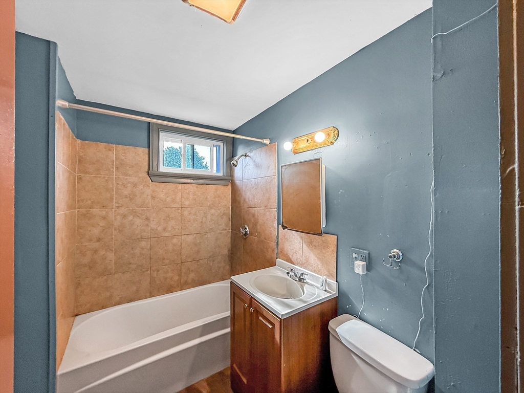 19 High Street Lynn, MA 01902 - Photo 29 of 42 a bathroom with a granite countertop sink toilet and shower