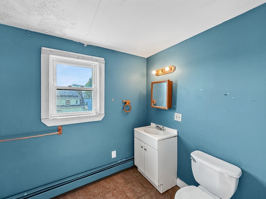 19 High Street Lynn, MA 01902 - Photo 30 of 42 a bathroom with a toilet sink and mirror