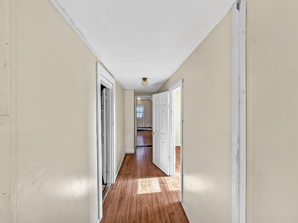 19 High Street Lynn, MA 01902 - Photo 32 of 42 a view of a hallway with wooden floor and staircase