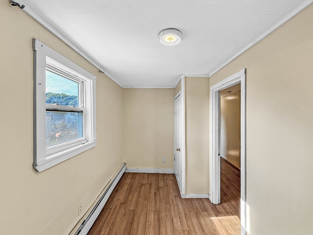19 High Street Lynn, MA 01902 - Photo 34 of 42 wooden floor in an empty room with a window