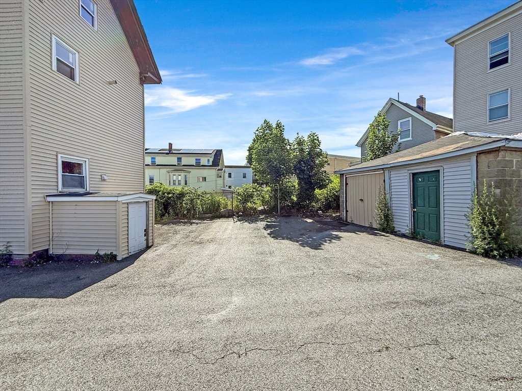 19 High Street Lynn, MA 01902 - Photo 40 of 42 a view of a house with backyard and a garage