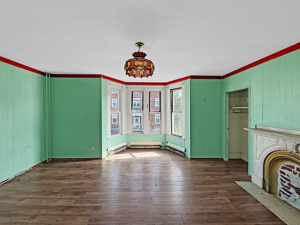19 High Street Lynn, MA 01902 - Photo 5 of 42 a view of empty room with window and fireplace