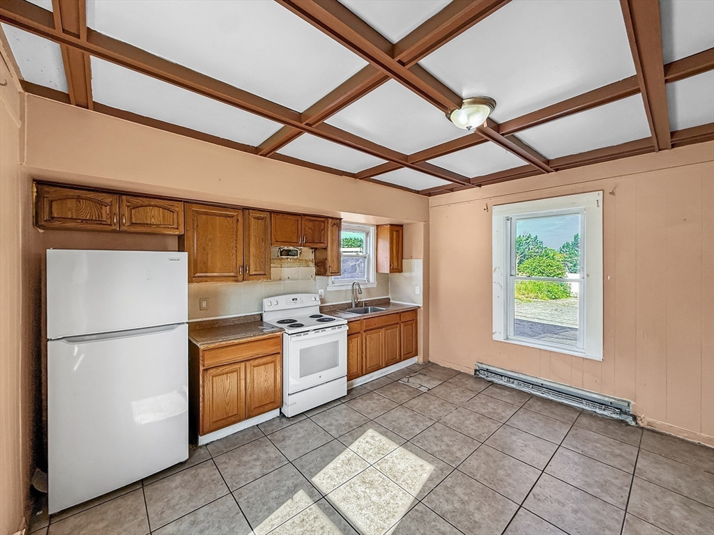 19 High Street Lynn, MA 01902 - Photo 8 of 42 a kitchen with stainless steel appliances granite countertop a refrigerator oven a sink and dishwasher