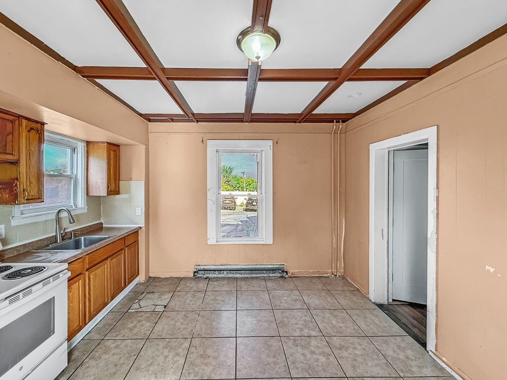 19 High Street Lynn, MA 01902 - Photo 9 of 42 a view of a kitchen with a sink and windows