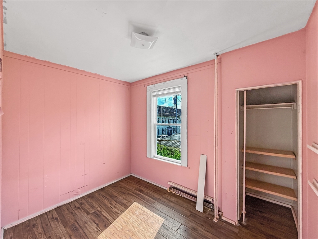 19 High Street Lynn, MA 01902 - Photo 10 of 42 a view of an empty room with wooden floor and a window