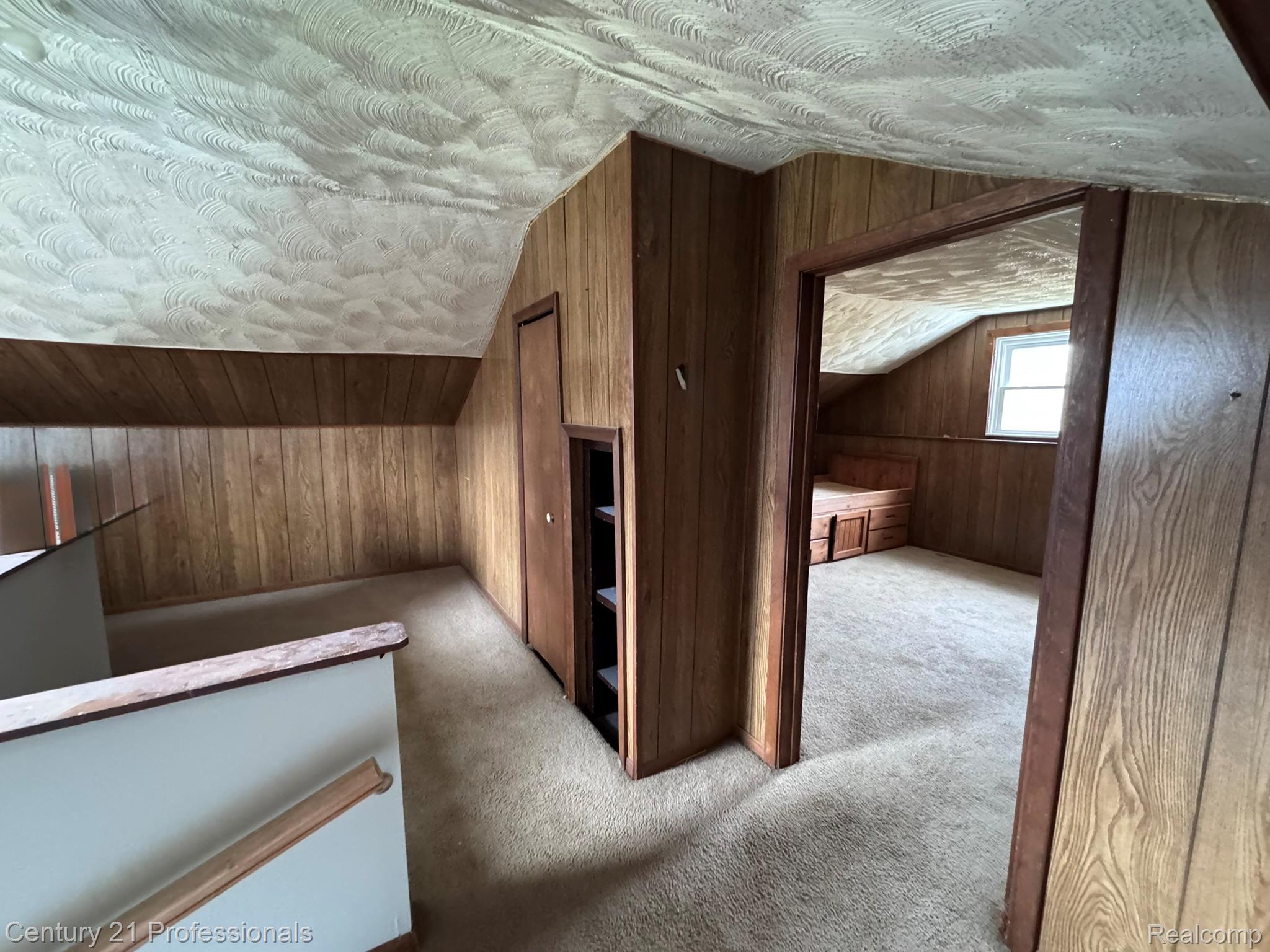 2021 West Rose Center Road Holly, MI 48442 - Photo 30 of 30 Bonus room with wood walls and light colored carpet
