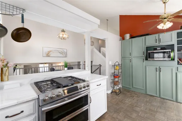 a stove top oven sitting inside of a kitchen