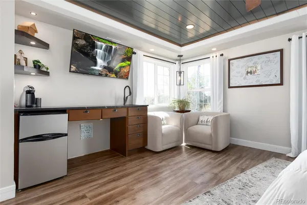 a living room with furniture and painting on the wall