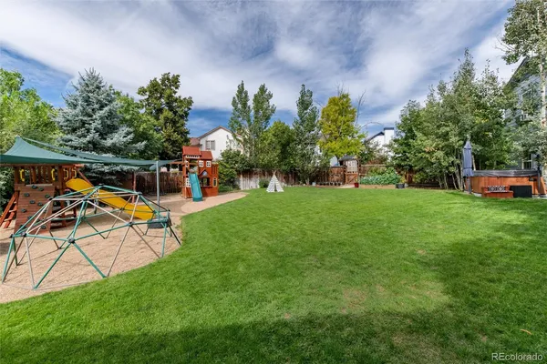a view of a house with a big yard and large trees