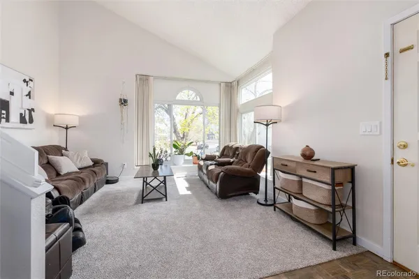 a living room with furniture a lamp and a window