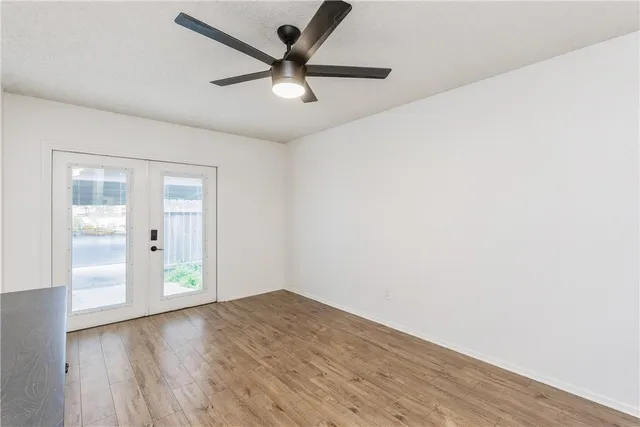 a view of a kitchen with wooden floor and a ceiling fan