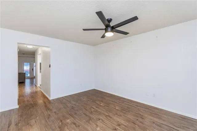 a view of a big room with wooden floor and wooden door