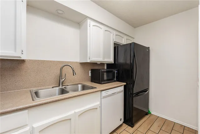 a kitchen with a sink cabinets and refrigerator