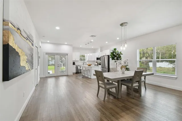 a view of a dining room with furniture window and wooden floor