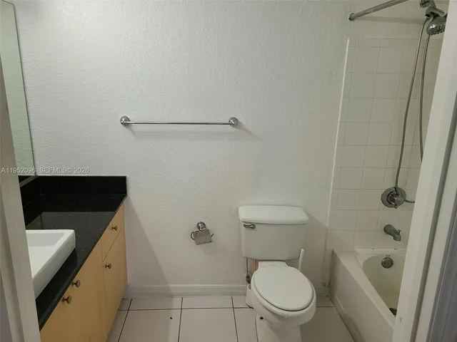 a view of a patio with a table chairs and a floor to ceiling window