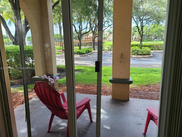 a view of a park with lawn chairs