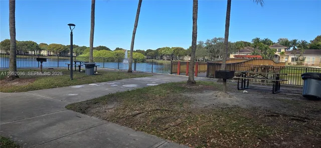 a hallway with wooden floor chandelier and entryway
