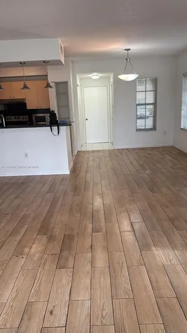 a swimming pool with a table and palm trees