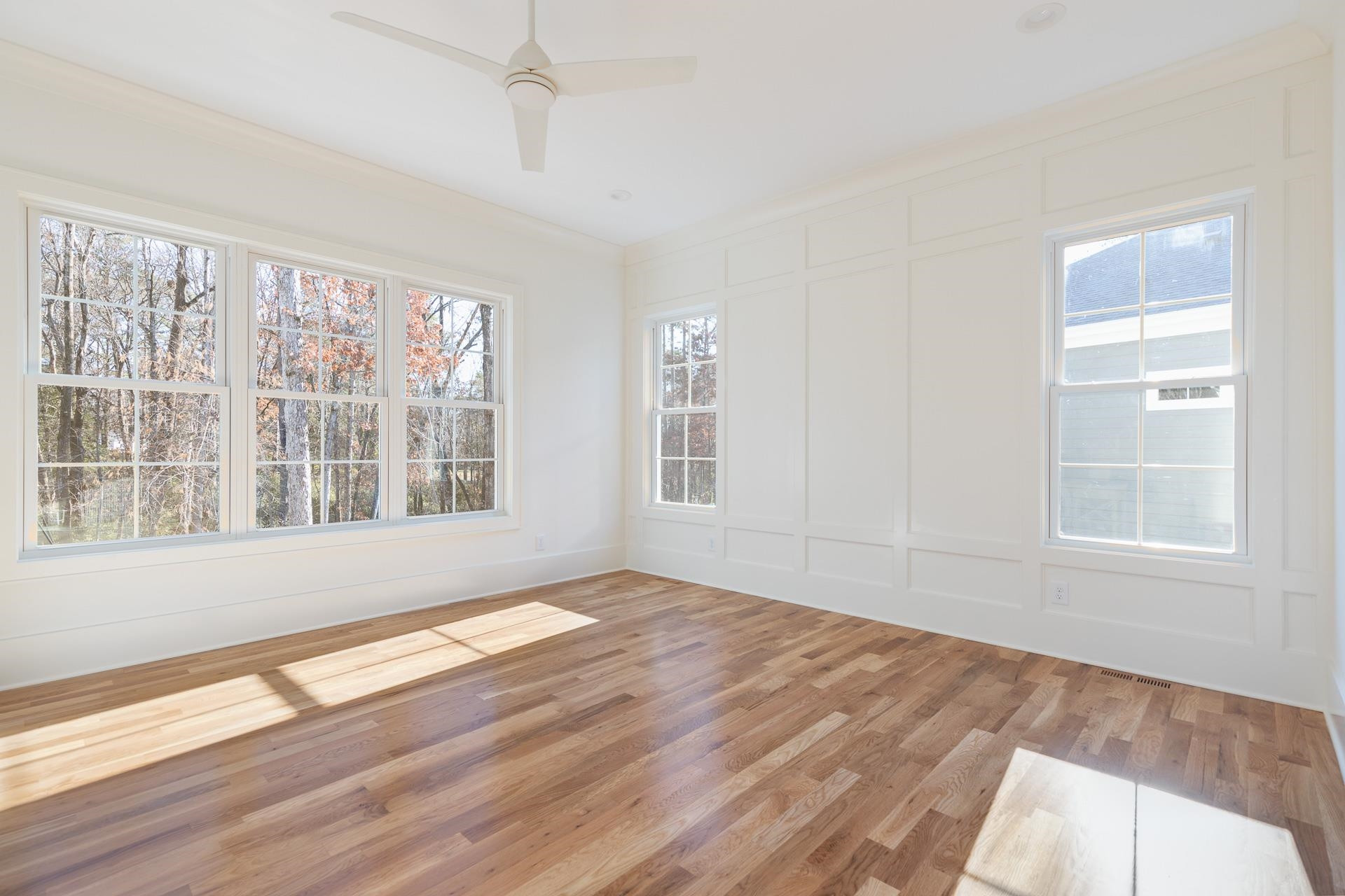 6312 Stephens Ridge Raleigh, NC 27615 - Photo 21 of 28 a view of an empty room with wooden floor and a window