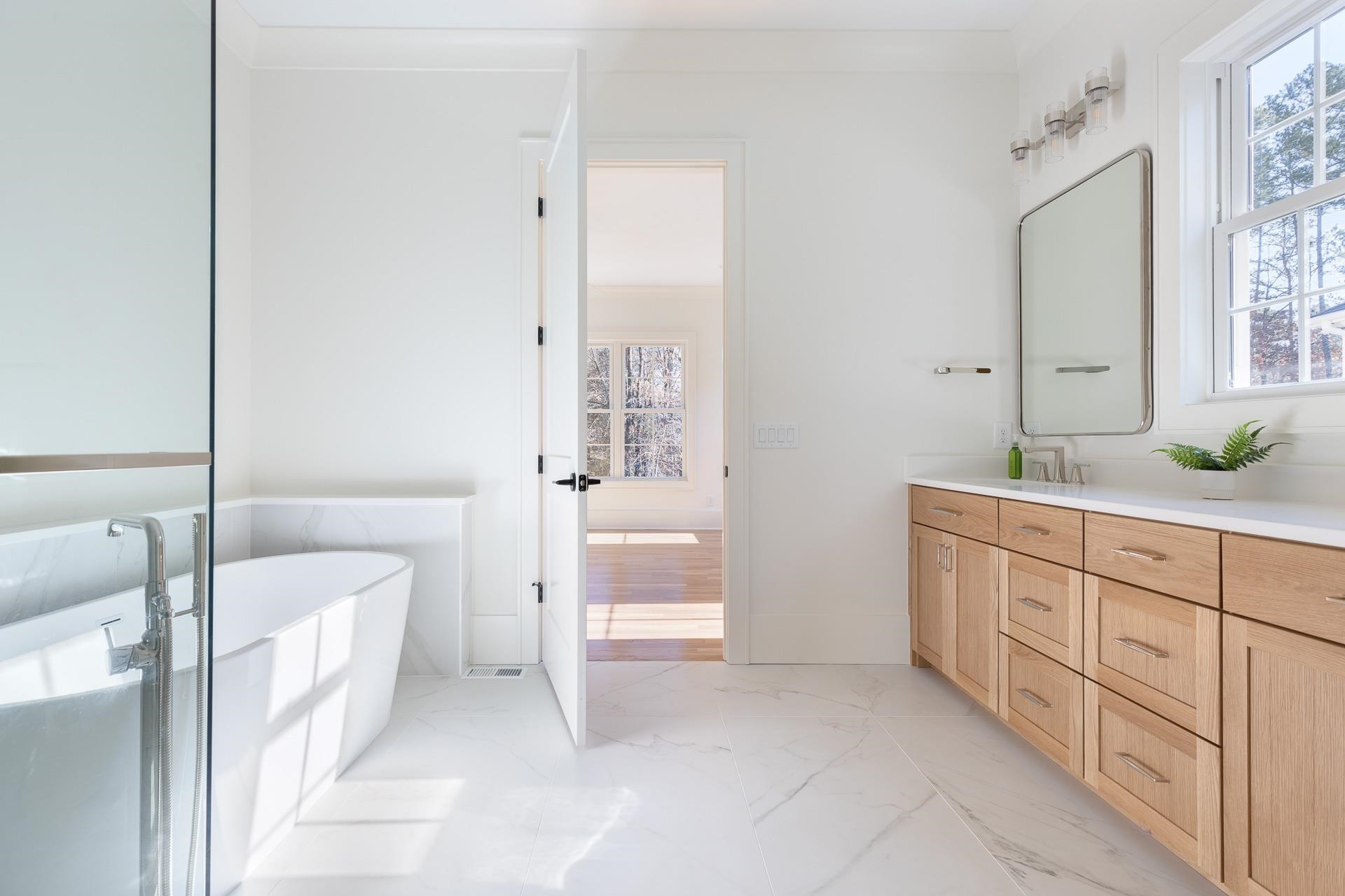 6312 Stephens Ridge Raleigh, NC 27615 - Photo 28 of 28 a spacious bathroom with a double vanity sink a mirror and a bathtub