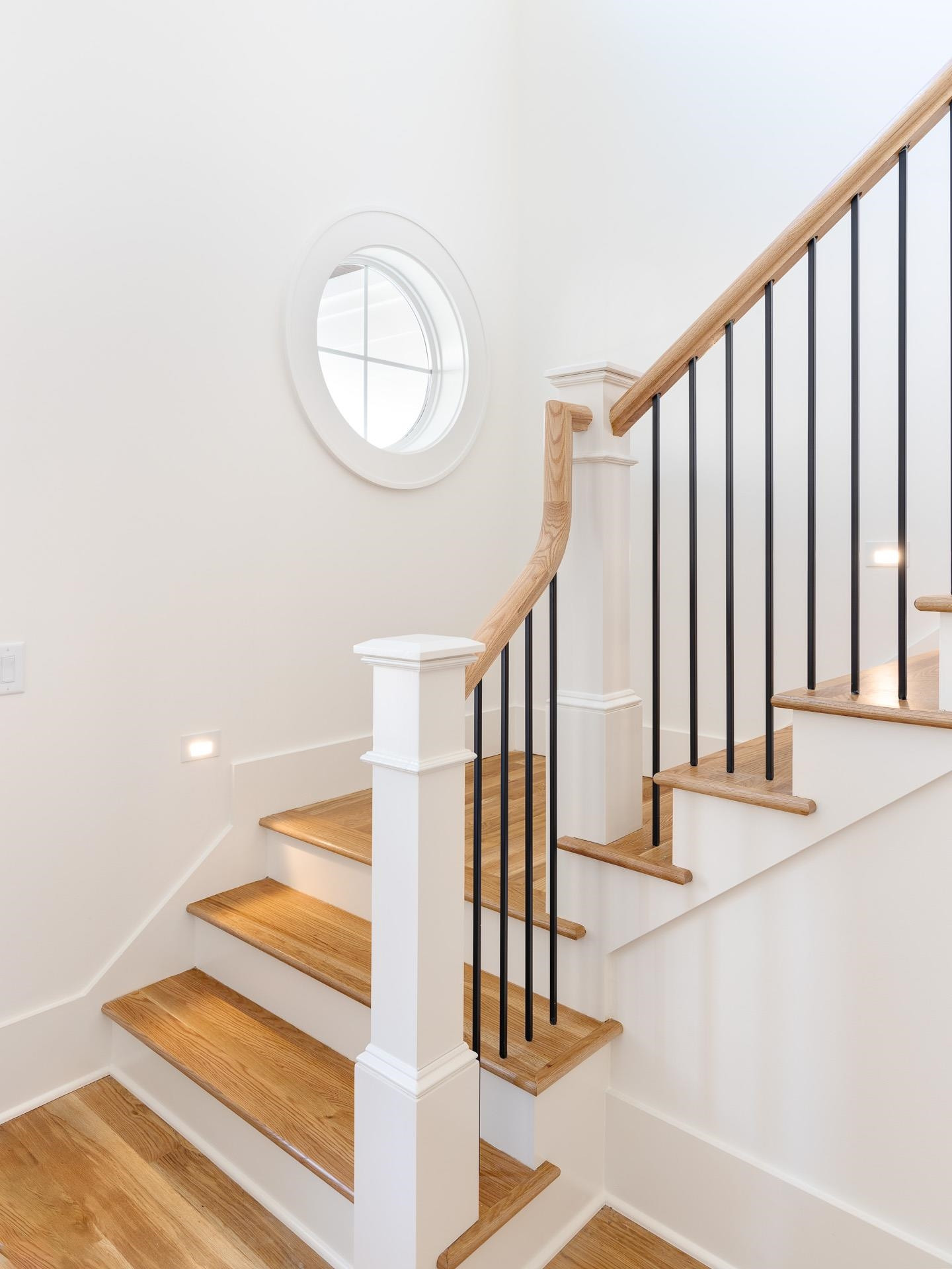 6312 Stephens Ridge Raleigh, NC 27615 - Photo 5 of 28 a view of staircase with white walls and a window