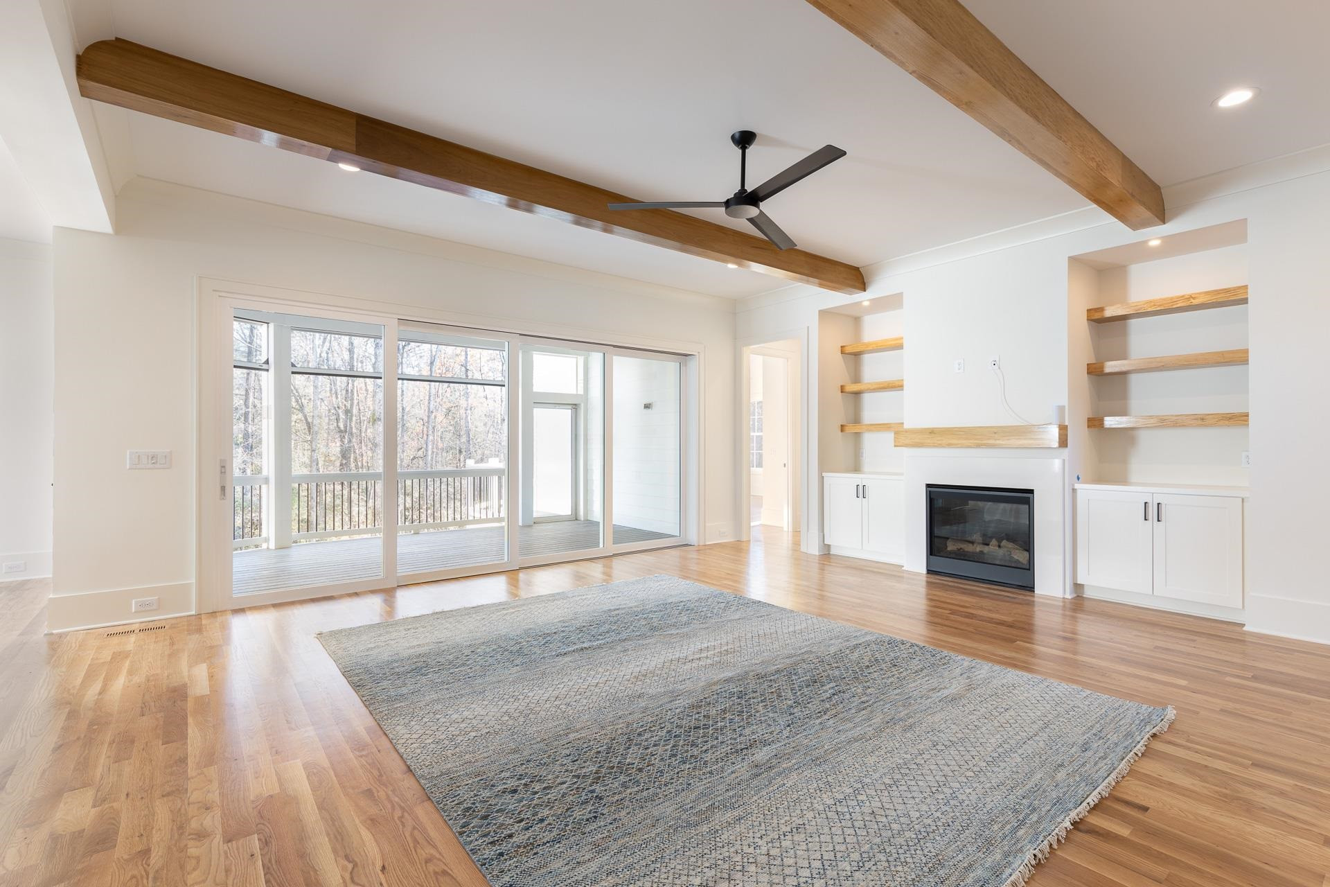 6312 Stephens Ridge Raleigh, NC 27615 - Photo 9 of 28 a view of empty room with wooden floor and fireplace