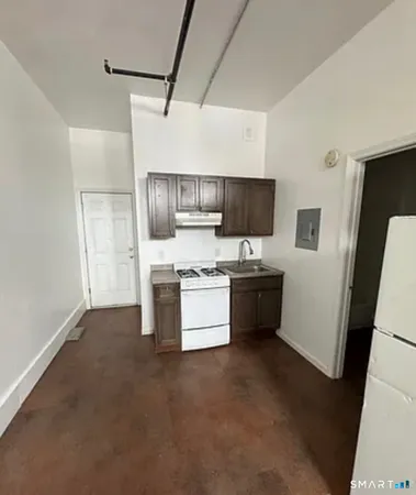a kitchen with stainless steel appliances a refrigerator and a stove top oven