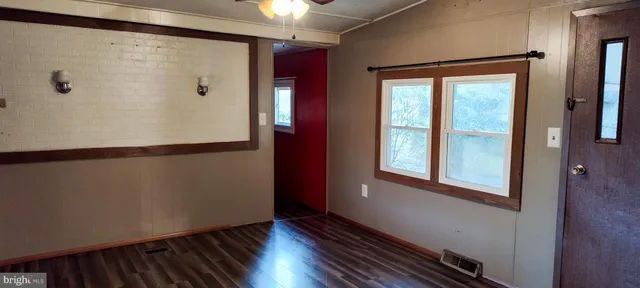 a view of a room with wooden floor and windows