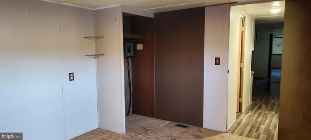 a view of hallway with wooden floor and staircase