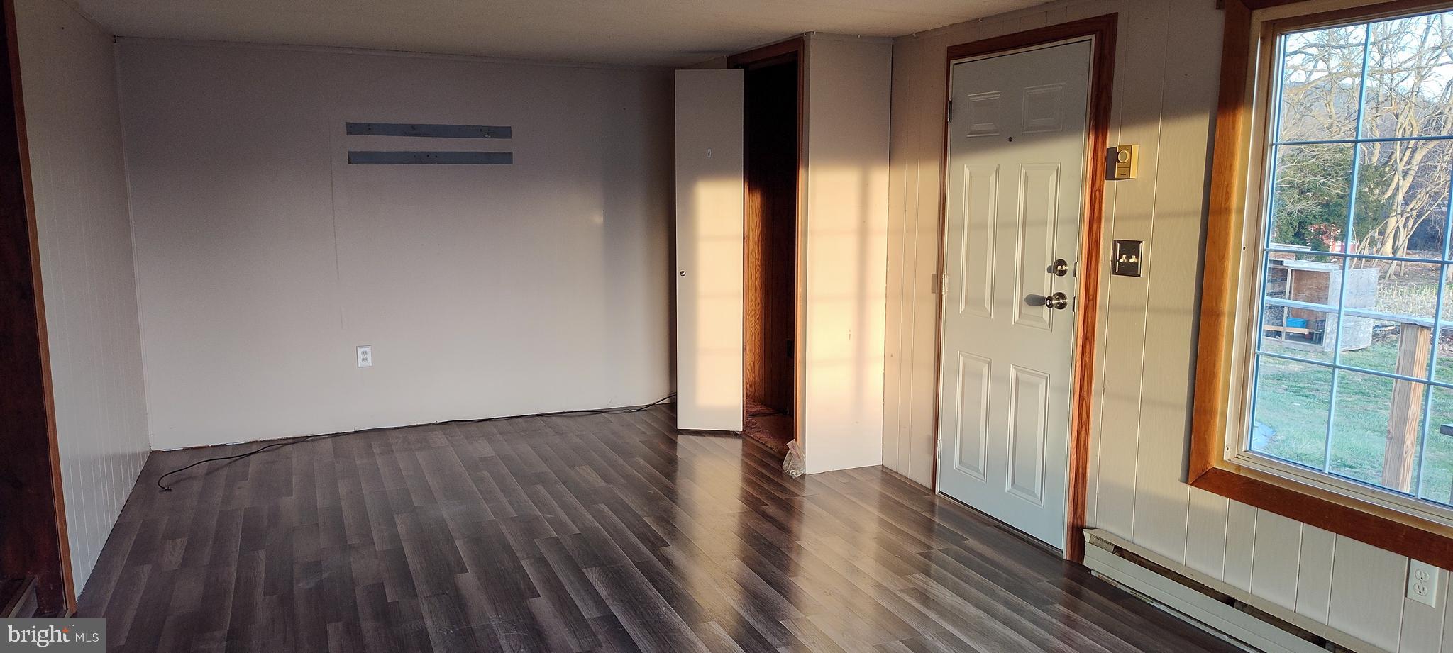 2633 Old Trail Road Liverpool, PA 17045 - Photo 10 of 32 a view of an empty room with wooden floor and a window