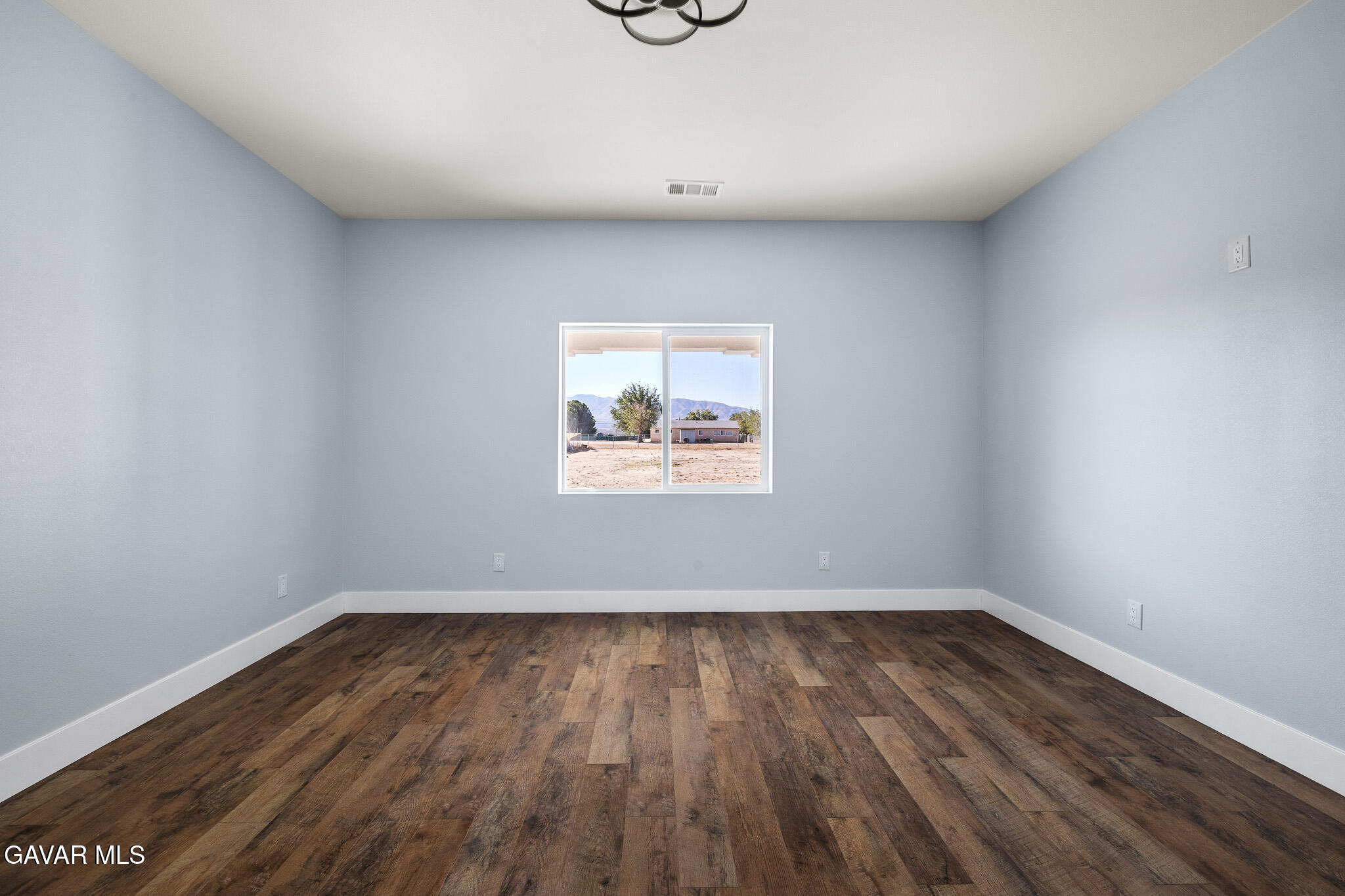 10708 East Ave R 14 Littlerock, CA 93543 - Photo 19 of 38 a view of empty room with wooden floor and fan