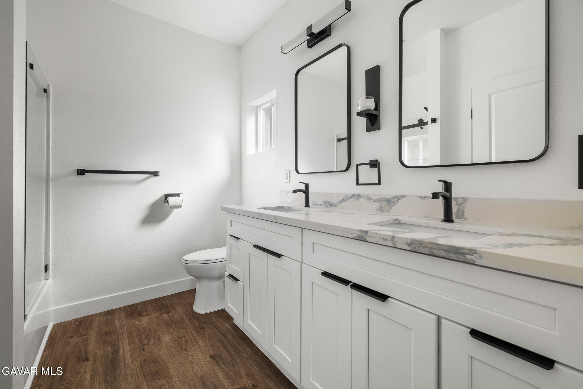 10708 East Ave R 14 Littlerock, CA 93543 - Photo 21 of 38 a bathroom with a double vanity sink and a mirror