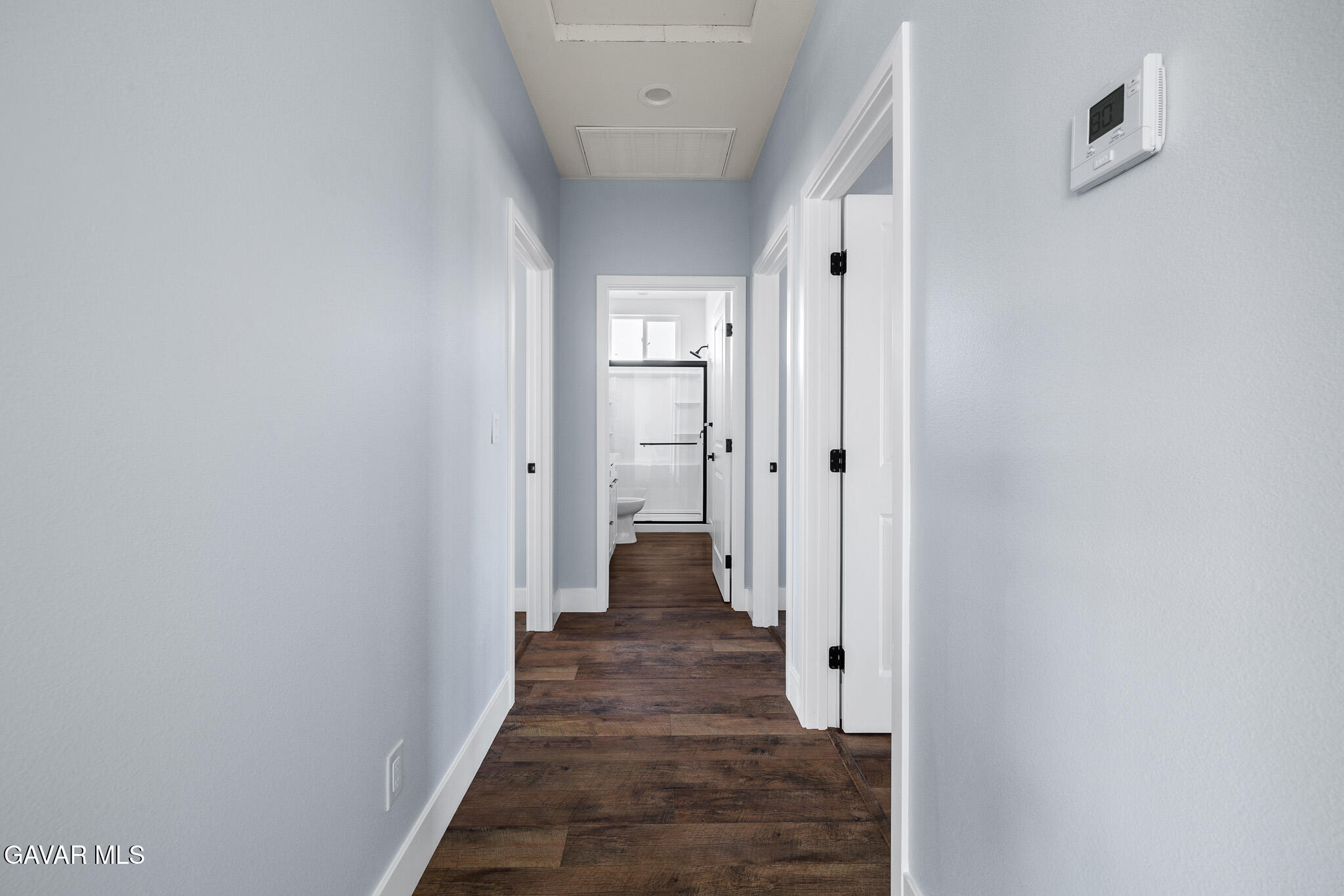 10708 East Ave R 14 Littlerock, CA 93543 - Photo 23 of 38 a view of a hallway with wooden floor and a bathroom