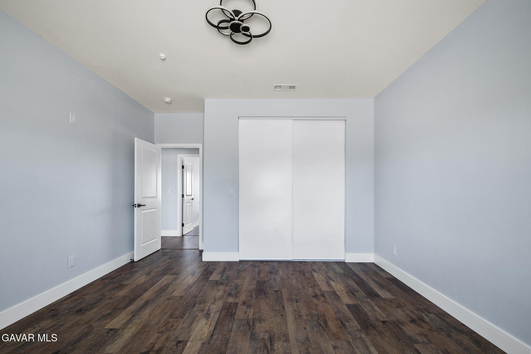 10708 East Ave R 14 Littlerock, CA 93543 - Photo 27 of 38 a view of an empty room with wooden floor