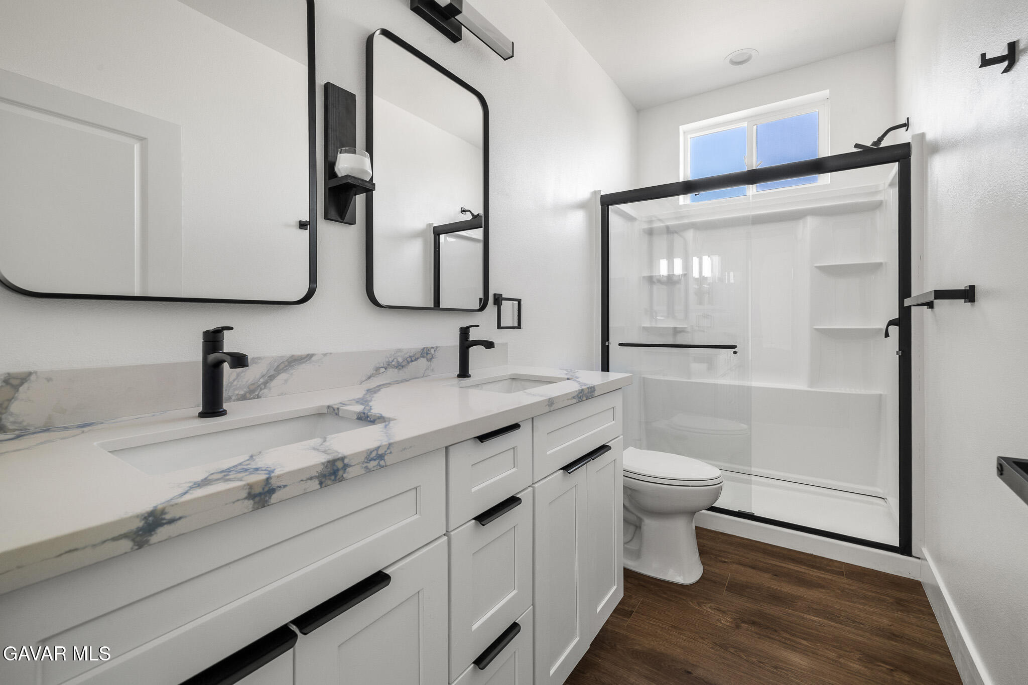 10708 East Ave R 14 Littlerock, CA 93543 - Photo 28 of 38 a bathroom with a granite countertop sink a toilet and a mirror
