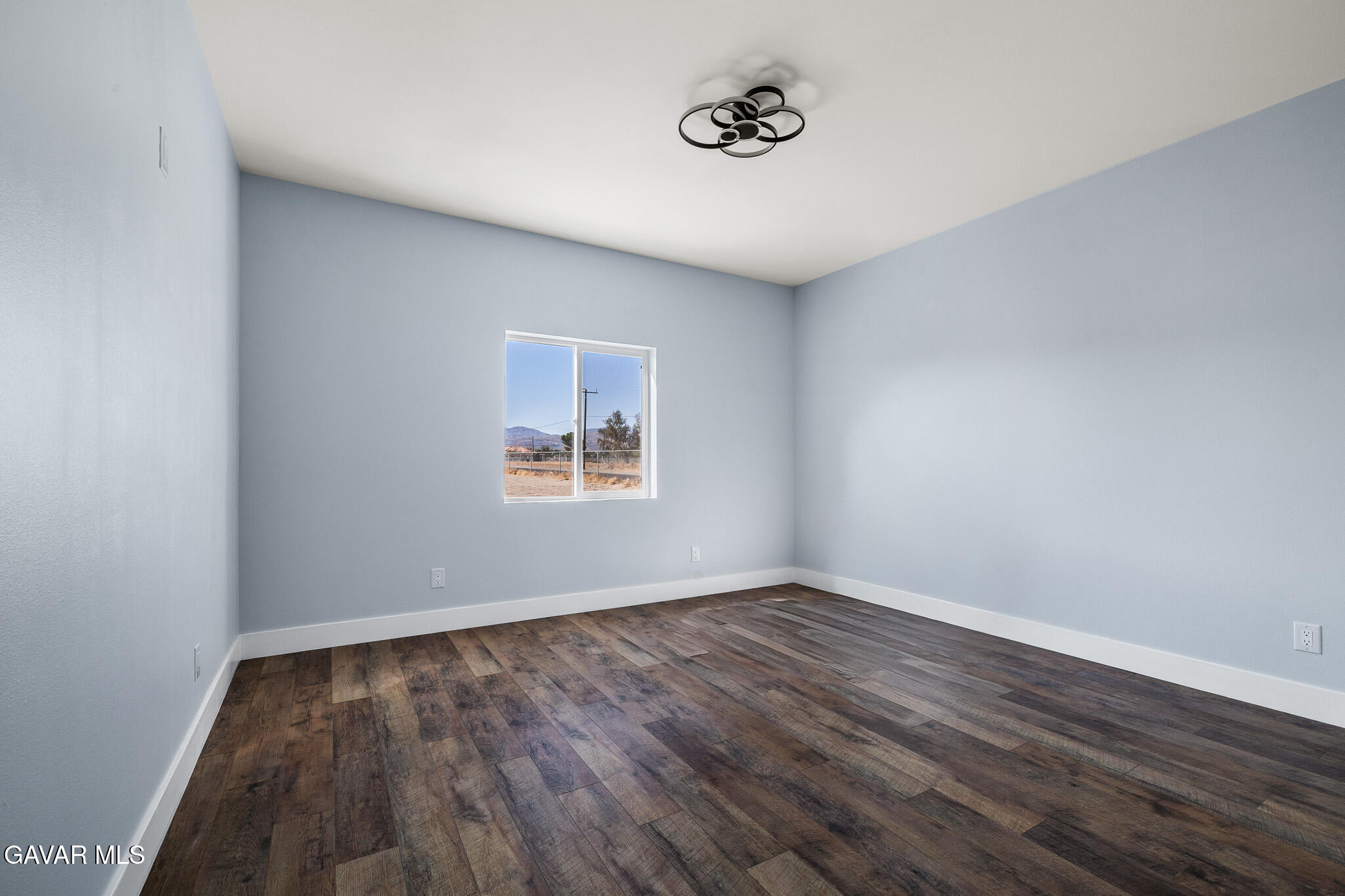 10708 East Ave R 14 Littlerock, CA 93543 - Photo 29 of 38 a view of an empty room with wooden floor and a window
