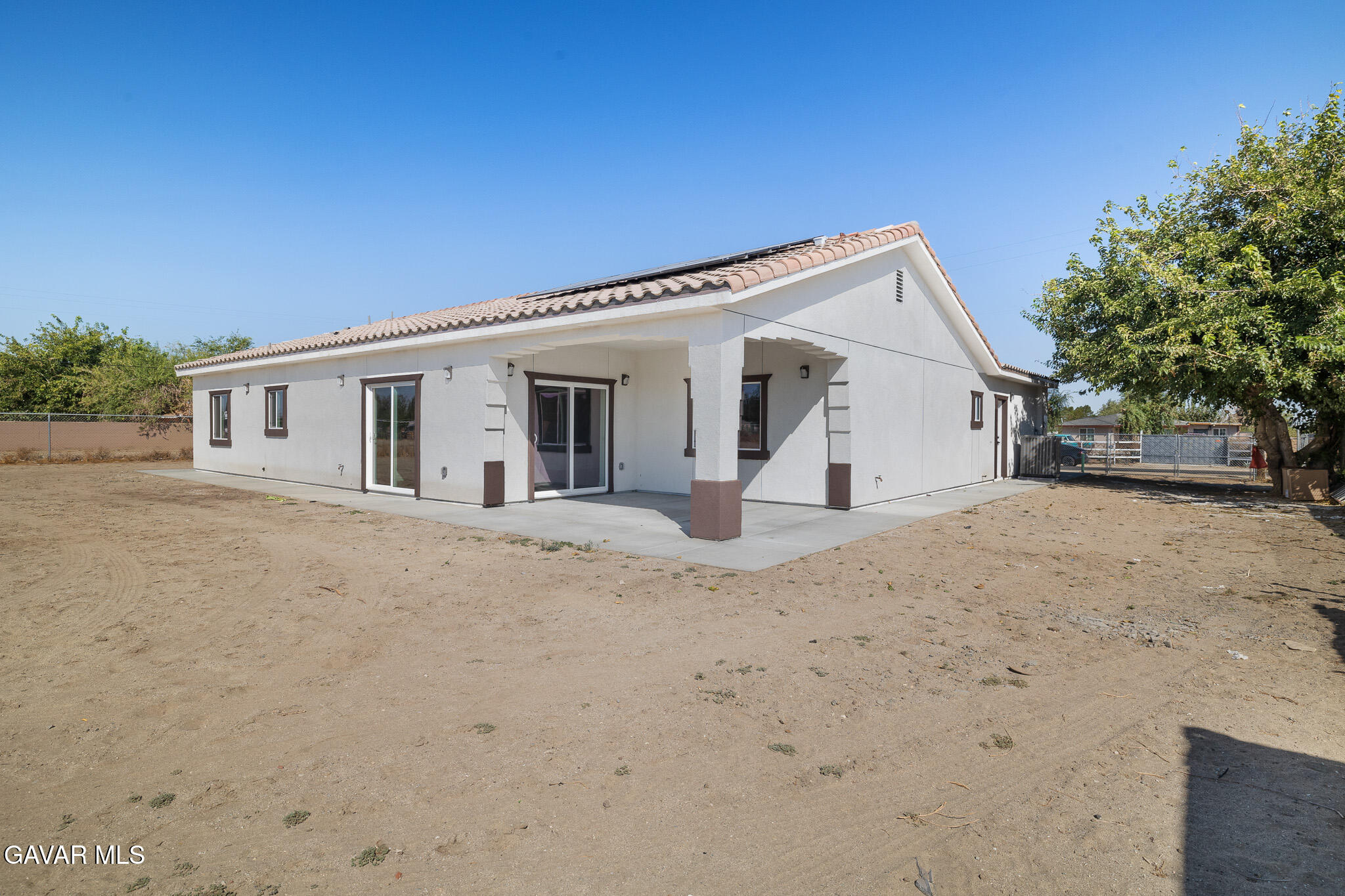 10708 East Ave R 14 Littlerock, CA 93543 - Photo 32 of 38 a view of a white house with a yard